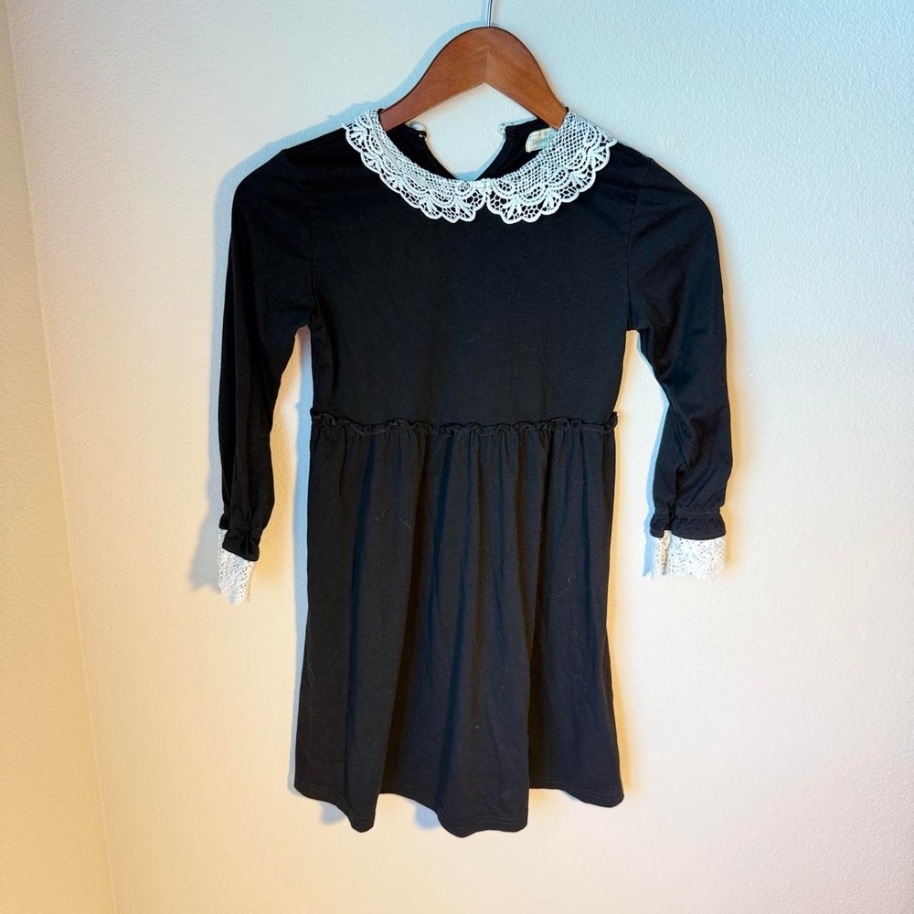 Girls' black dress with white lace collar and cuffs